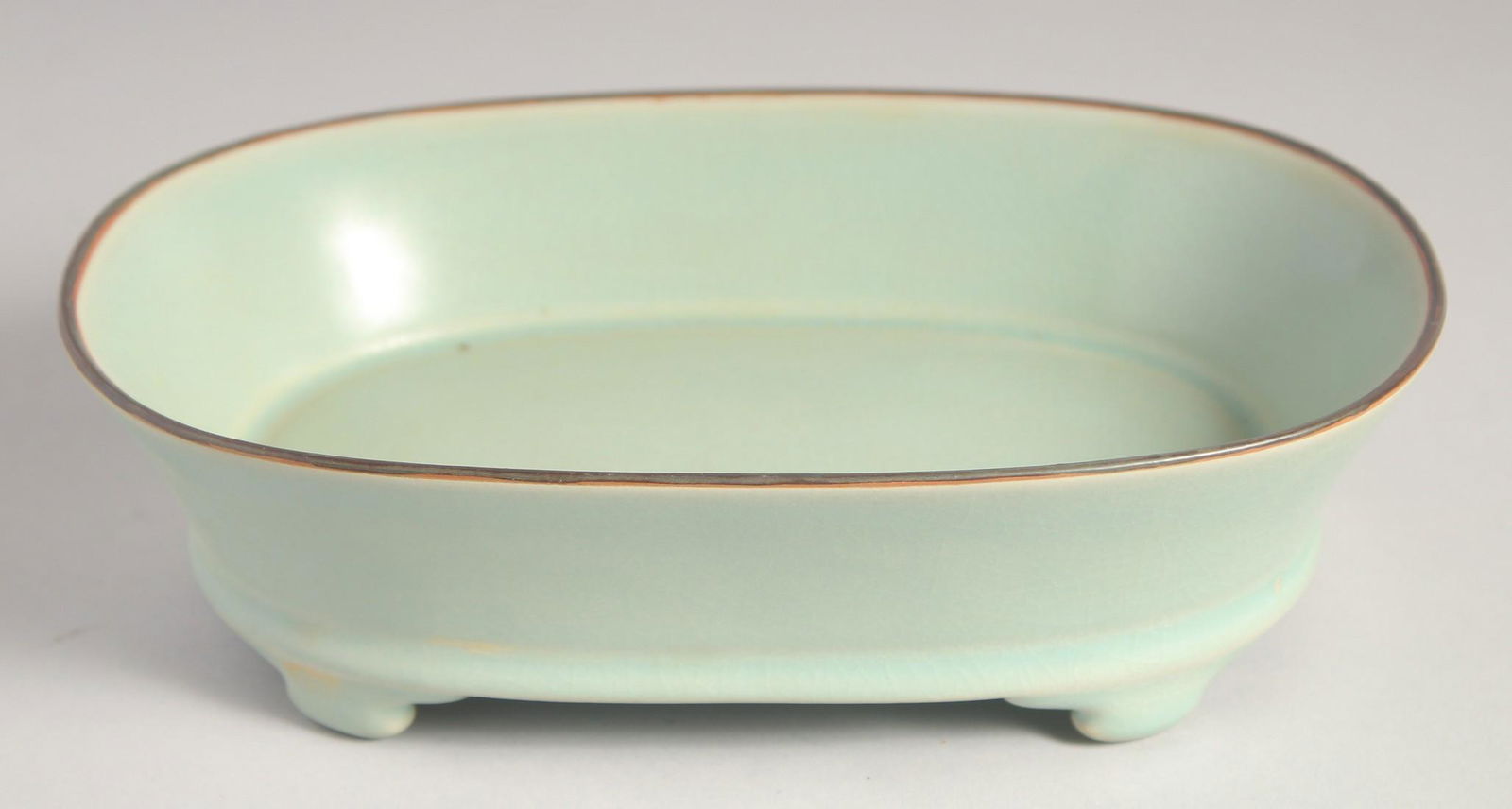 A CHINESE RU WARE CELADON PLANT POT, raised on four feet, 23.5cm wide. (1 of 4)