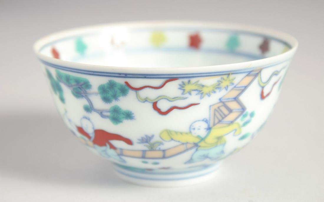 A CHINESE DOUCAI EGGSHELL PORCELAIN CUP painted with children playing, the base with six-character (1 of 7)