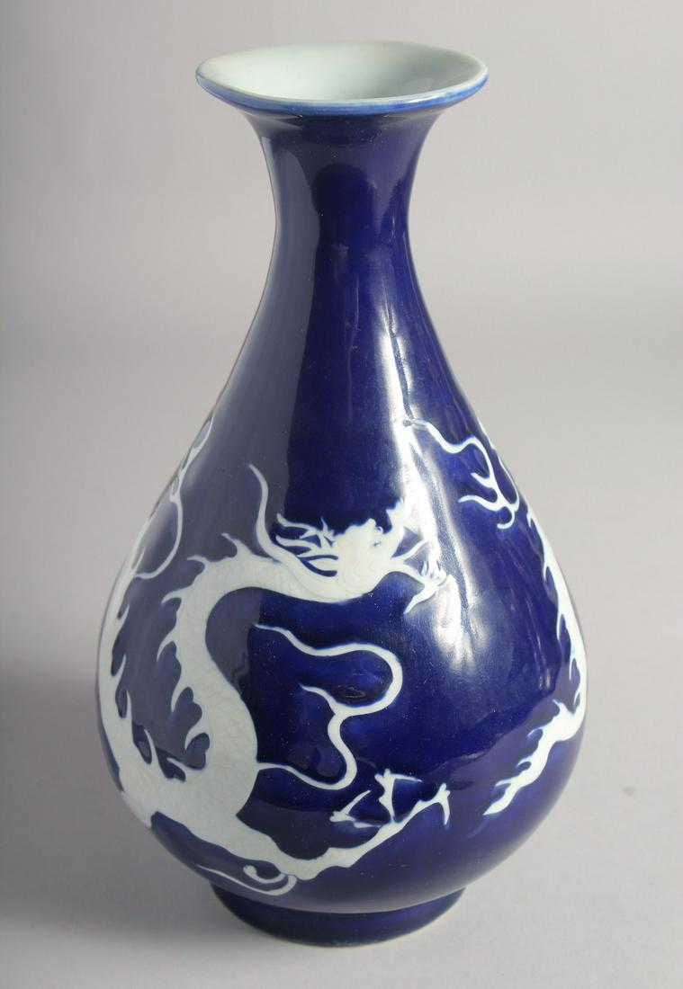 A CHINESE SACRIFICIAL BLUE YUHUCHUNPING VASE decorated with white carved dragon. 27.5cm high: A CHINESE SACRIFICIAL BLUE YUHUCHUNPING VASE decorated with white carved dragon. 27.5cm high
