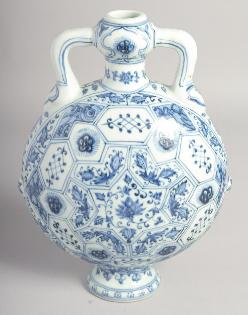 A CHINESE BLUE AND WHITE PORCELAIN TWIN HANDLED MOON FLASK decorated with lotus and further panels (1 of 6)