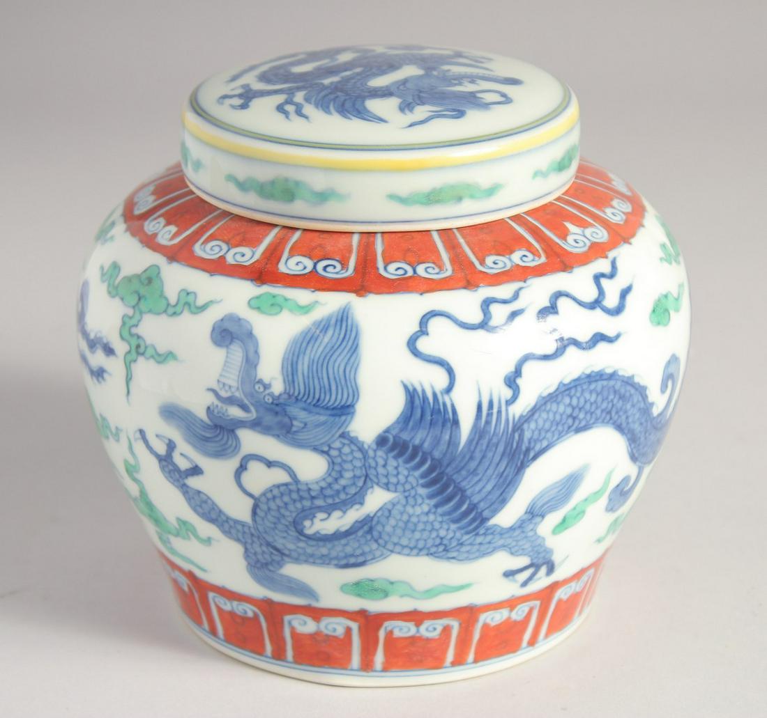 A CHINESE DOUCAI PORCELAIN JAR AND COVER, painted with dragons, Tian mark to base, 13cm high. (1 of 8)