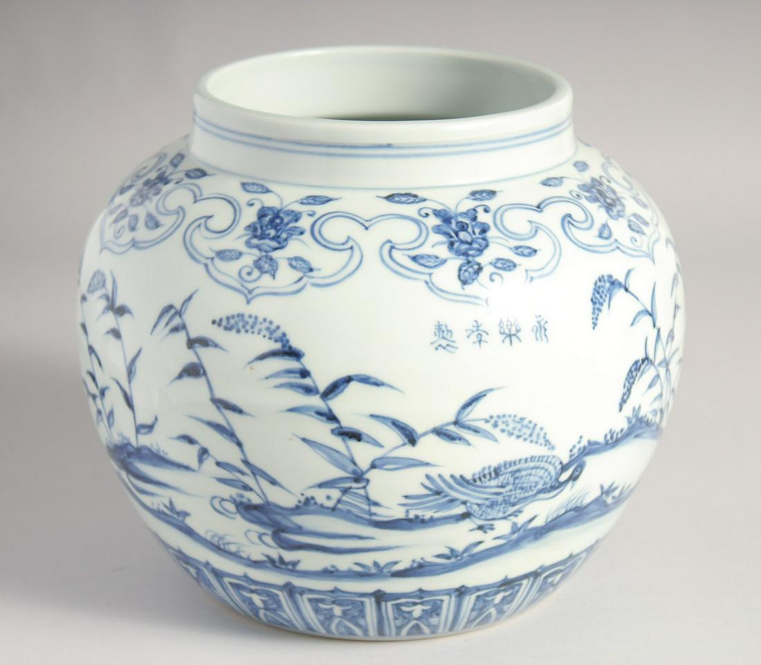 A CHINESE BLUE AND WHITE PORCELAIN JARDINIERE, painted with birds and flora, four-character mark,: A CHINESE BLUE AND WHITE PORCELAIN JARDINIERE, painted with birds and flora, four-character mark, 20cm high.
