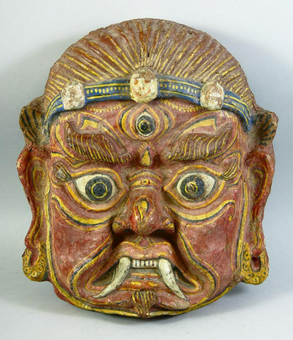 A LARGE TIBETAN CEREMONIAL PAPIER MACHE MASK, 43cm x 38cm. (1 of 3)