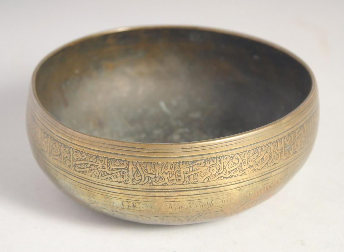A 15TH/16TH CENTURY MAMLUK ENGRAVED BRASS BOWL, the exterior with a band of calligraphy. 15.5cm: A 15TH/16TH CENTURY MAMLUK ENGRAVED BRASS BOWL, the exterior with a band of calligraphy. 15.5cm diameter
