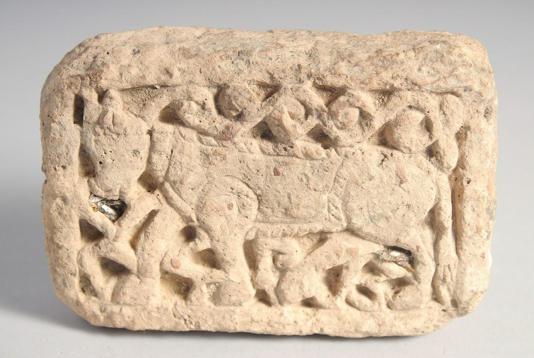 A RARE 12TH/13TH CENTURY PERSIAN SELJUK CLAY BRICK, depicting a bull, 12.5cm x 9cm.: A RARE 12TH/13TH CENTURY PERSIAN SELJUK CLAY BRICK, depicting a bull, 12.5cm x 9cm.