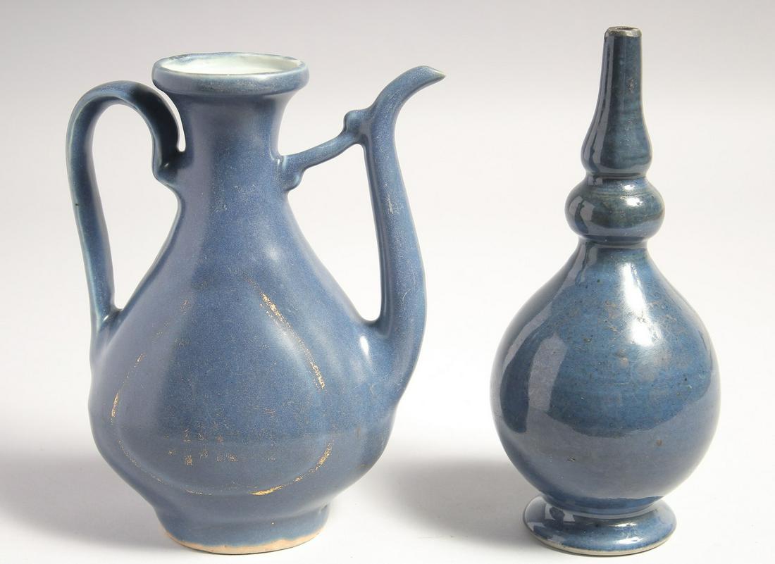 A CHINESE MING DYNASTY MONOCHROME-BLUE WINE EWER, together with a bottle vase in a fitted: A CHINESE MING DYNASTY MONOCHROME-BLUE WINE EWER, together with a bottle vase in a fitted presentation case, the ewer and vase with traces of gilt decoration, ewer 19cm high, bottle vase 20cm high, (2