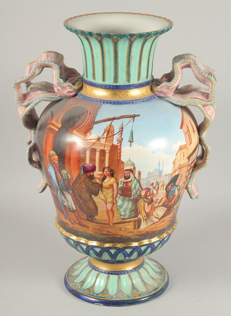 A LARGE ORIENTAL TWIN HANDLE PORCELAIN VASE, painted with an Arab market scene, the front of the (1 of 6)