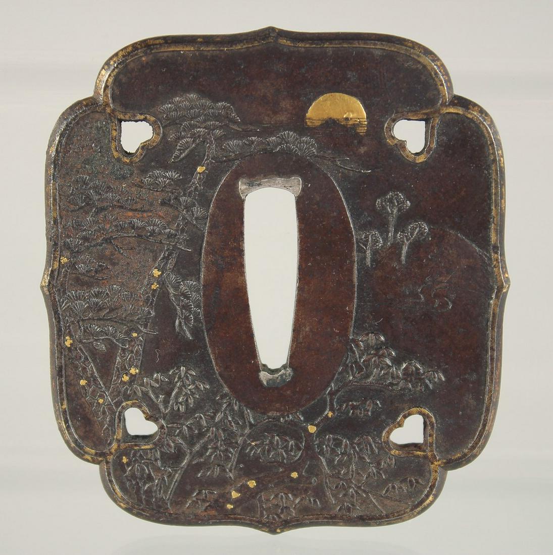 A JAPANESE BRONZE TSUBA, with raised decoration to both sides depicting landscapes with gilt (1 of 2)