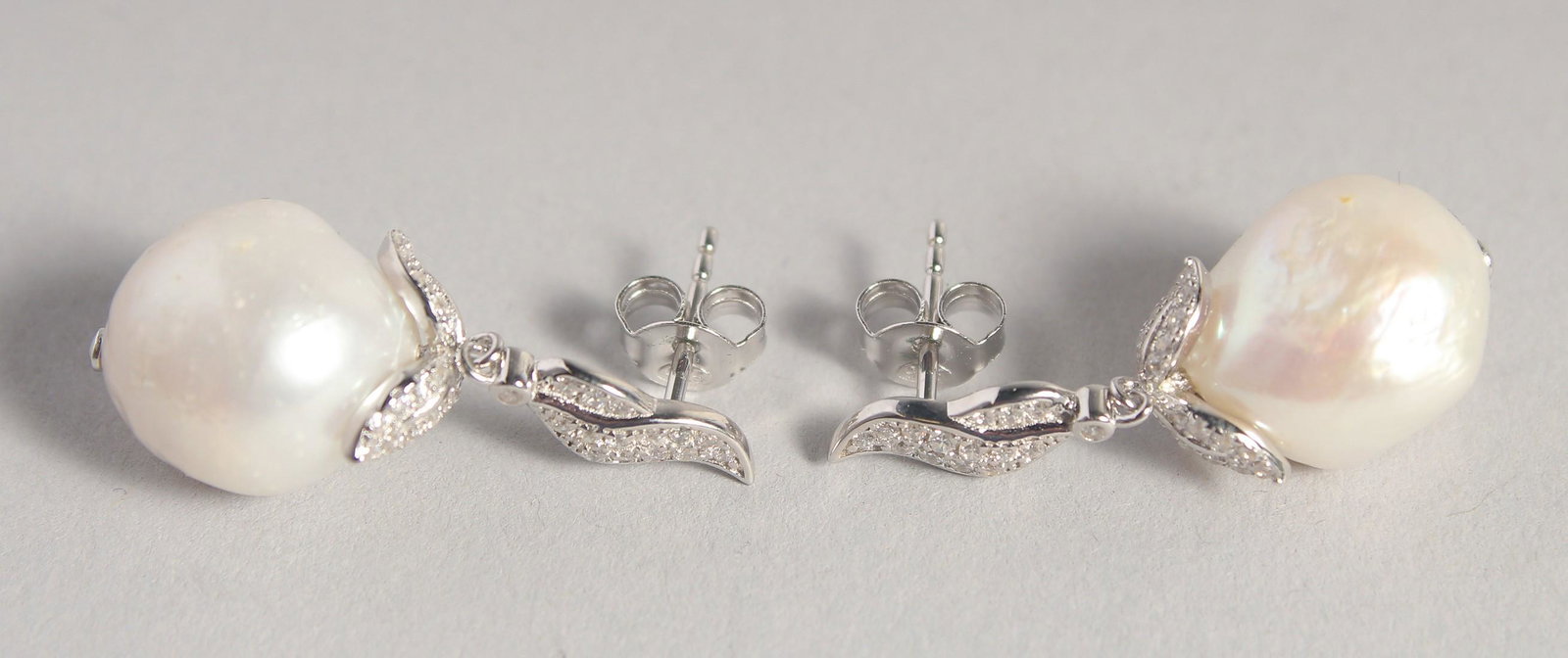 A PAIR OF SILVER BAROQUE PEARL DROP EARRINGS.: A PAIR OF SILVER BAROQUE PEARL DROP EARRINGS.