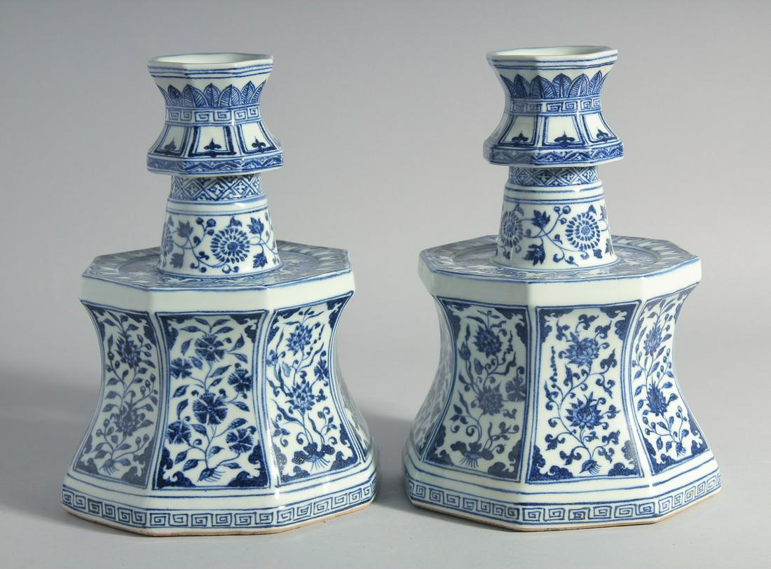 A LARGE PAIR OF CHINESE BLUE AND WHITE PORCELAIN CANDLESTICKS, decorated with panels of flora, 27cm: A LARGE PAIR OF CHINESE BLUE AND WHITE PORCELAIN CANDLESTICKS, decorated with panels of flora, 27cm high.