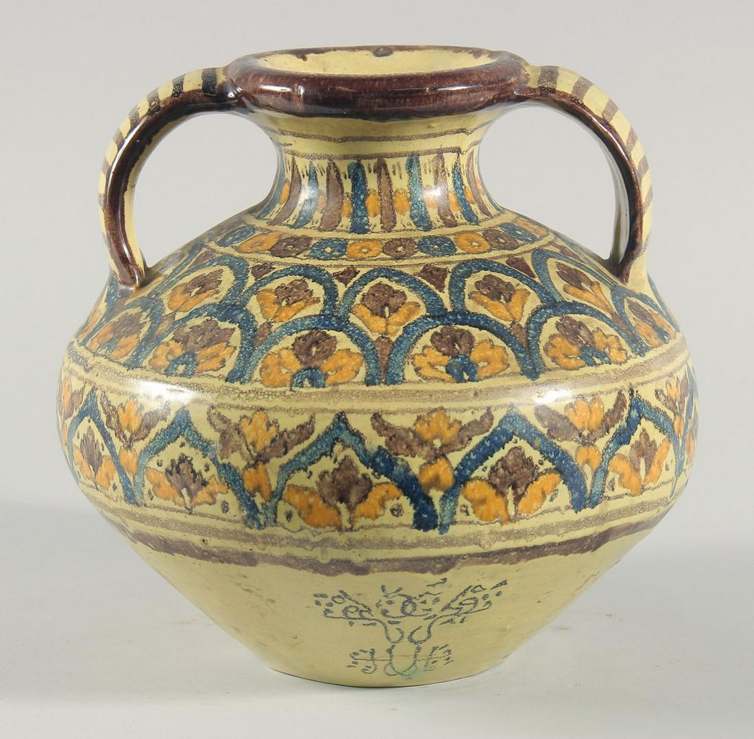 A FINE LARGE 19TH CENTURY NORTH AFRICAN TUNISIAN GLAZED POTTERY VASE, with twin handles, signed,: A FINE LARGE 19TH CENTURY NORTH AFRICAN TUNISIAN GLAZED POTTERY VASE, with twin handles, signed, painted with foliate motifs, 25cm high.