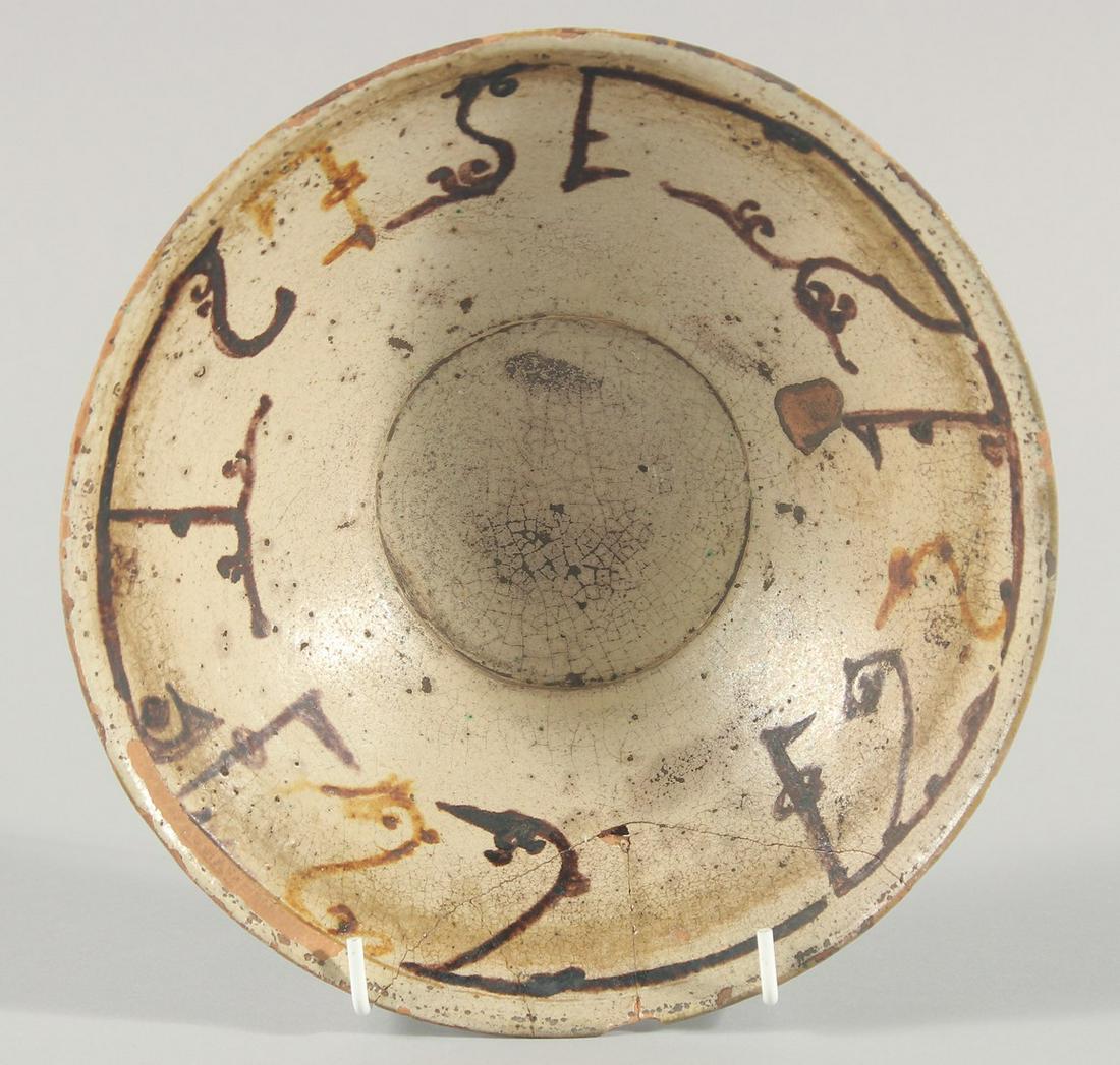 AN EARLY ISLAMIC PERSIAN KUFIC POTTERY BOWL, 21cm diameter.: AN EARLY ISLAMIC PERSIAN KUFIC POTTERY BOWL, 21cm diameter.