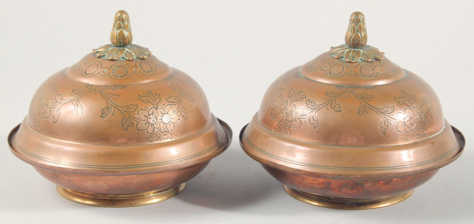 A RARE PAIR OF 18TH CENTURY OTTOMAN TURKISH GILDED COPPER TOMBAK LIDDED DISHES, with gold traces to: A RARE PAIR OF 18TH CENTURY OTTOMAN TURKISH GILDED COPPER TOMBAK LIDDED DISHES, with gold traces to the inner lids and bases, each 19cm diameter.