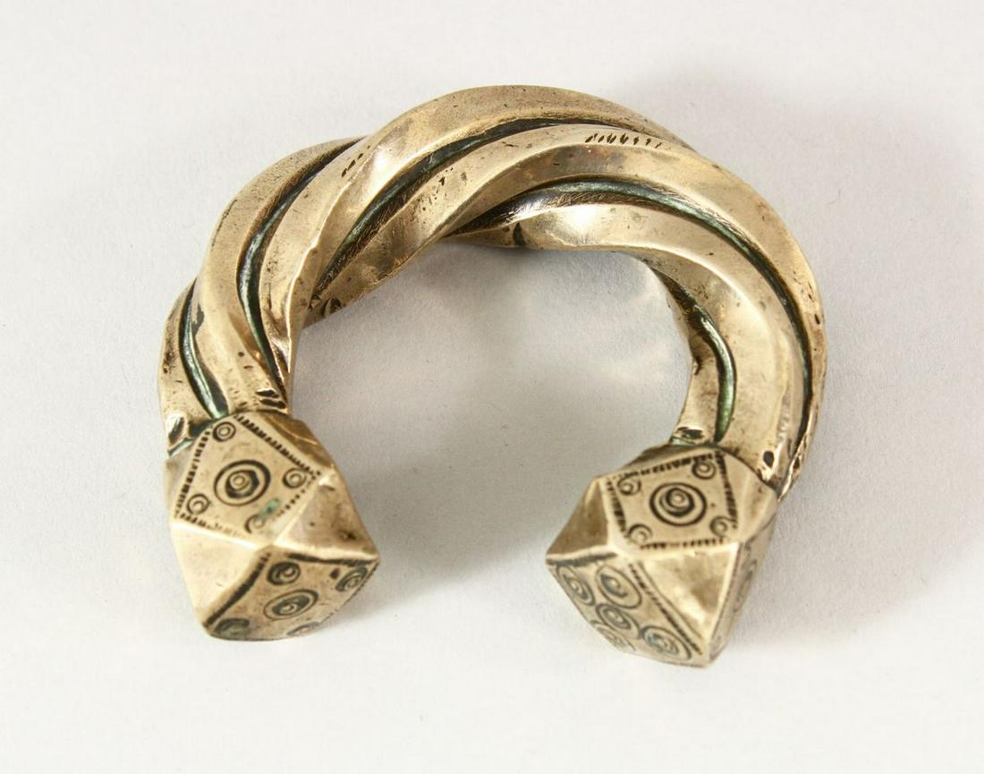 A SEJLUK WHITE METAL TWISTED BANGLE, The lower with a hallmark or makers mark. 8cm: A SEJLUK WHITE METAL TWISTED BANGLE, The lower with a hallmark or makers mark. 8cm