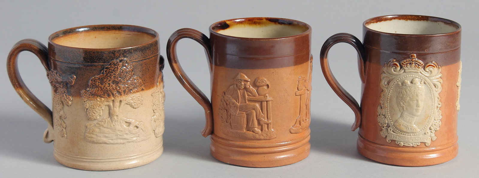 THREE VARIOUS ROYAL DOULTON STONEWARE MUGS. 3.5ins high.: THREE VARIOUS ROYAL DOULTON STONEWARE MUGS. 3.5ins high.