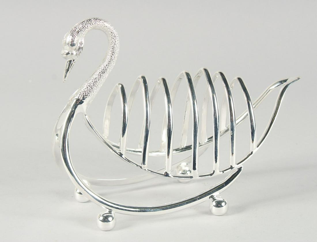 A SILVER PLATED SWAN SIX DIVISION TOAST RACK on ball feet. 6ins long.: A SILVER PLATED SWAN SIX DIVISION TOAST RACK on ball feet. 6ins long.