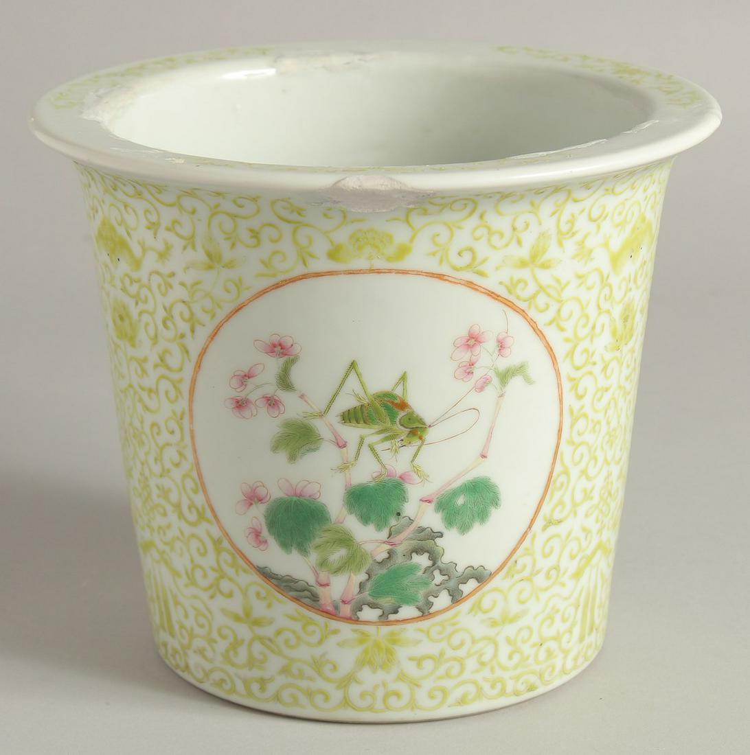 A CHINESE FAMILLE ROSE PORCELAIN PLANT POT, decorated with a panel of an insect and two panels of: A CHINESE FAMILLE ROSE PORCELAIN PLANT POT, decorated with a panel of an insect and two panels of flora, the base with six-character mark in red, (with faults), 15cm high.