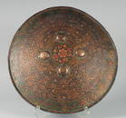 A FINE EARLY 19TH CENTURY NORTH INDIAN MUGHAL LACQUERED AND PAINTED LEATHER SHIELD, with embossed