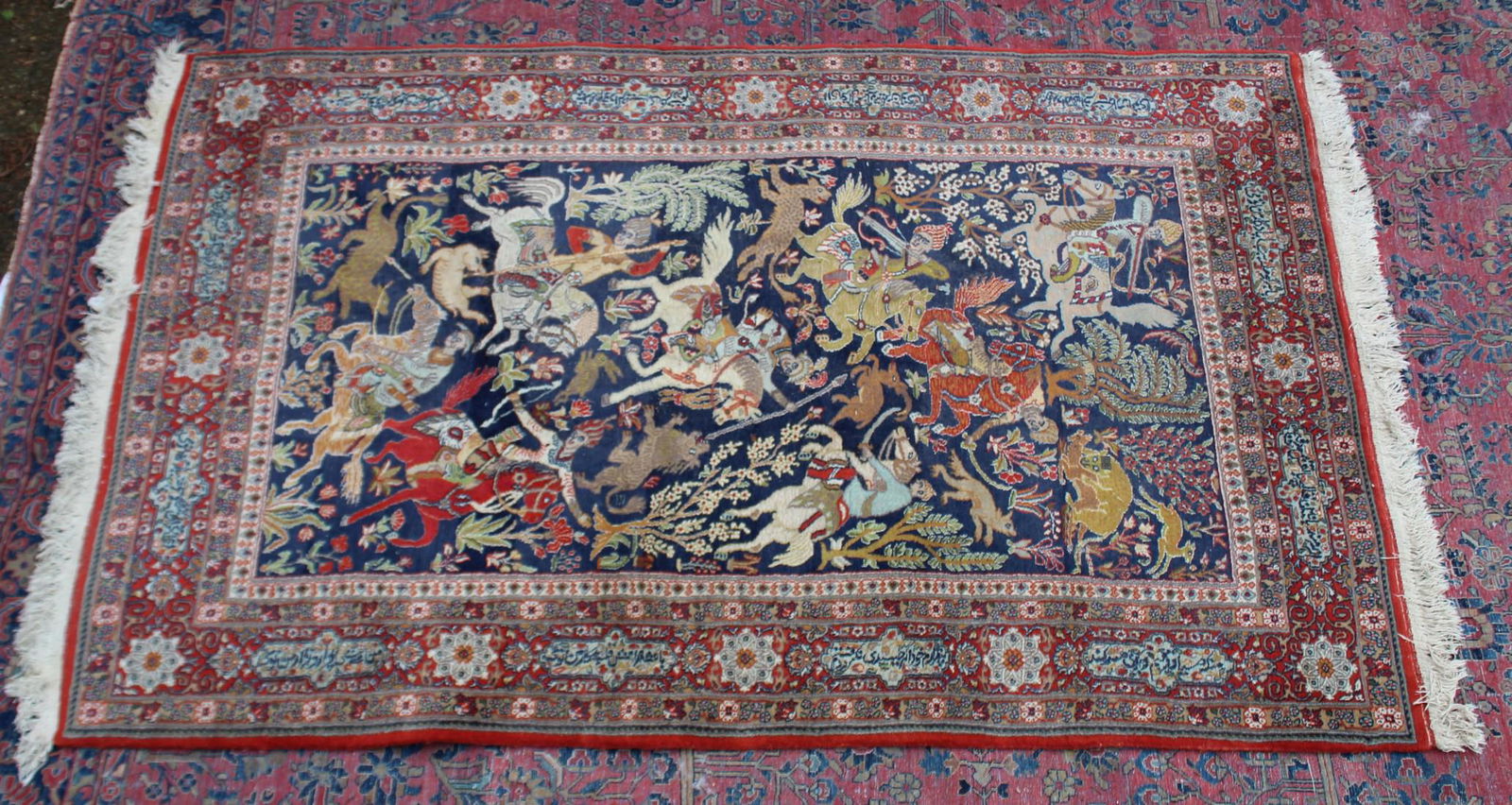A GOOD PERSIAN HUNTING CARPET, blue ground with figures on horseback with bows and arrows and: A GOOD PERSIAN HUNTING CARPET, blue ground with figures on horseback with bows and arrows and spears. 7'2" x 4'6"