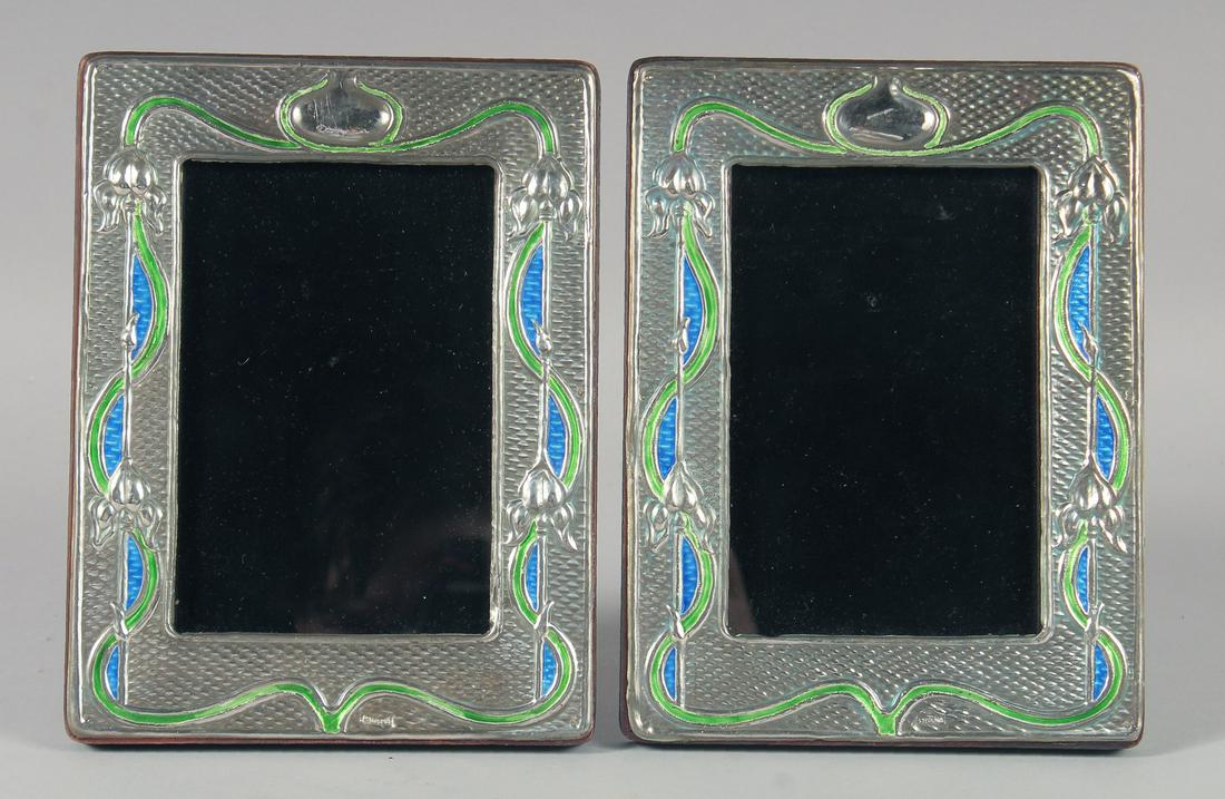A PAIR OF SILVER AND ENAMEL PHOTOGRAPH FRAMES. 19.5cm high: A PAIR OF SILVER AND ENAMEL PHOTOGRAPH FRAMES. 19.5cm high