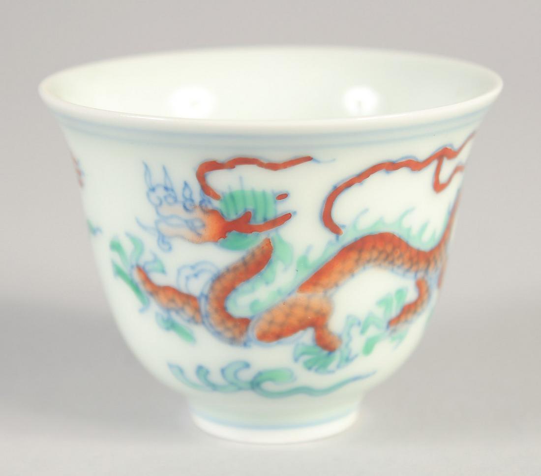 A CHINESE DOUCAI PORCELAIN DRAGON CUP, six-character mark to base, 6.5cm diameter. (1 of 4)