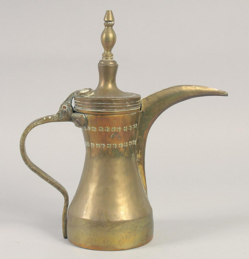 AN ISLAMIC SIGNED BRASS COFFEE POT, 29.5cm high. (1 of 7)