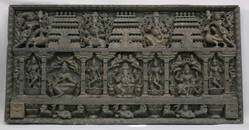 A MONUMENTAL DEEPLY CARVED WOODEN PANEL, depicting various Hindu gods seated on a lotus wearing