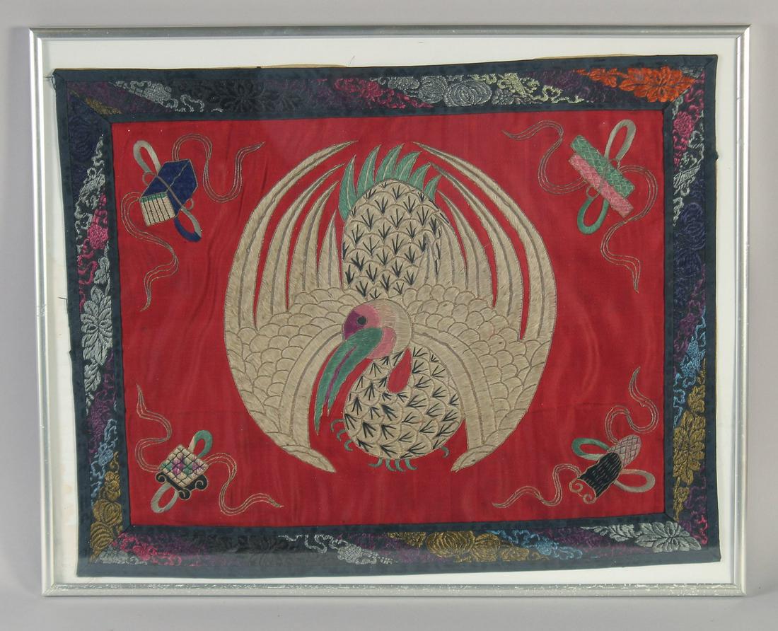 AN EARLY 20TH CENTURY CHINESE TEXTILE OF A PHOENIX, framed and glazed, textile 46cm x 36cm. (1 of 2)