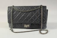 A CHANEL PADDED BLUE BAG.  32cm long, 20cm high with long chrome chain 48cm, in a Chanel dust bag.