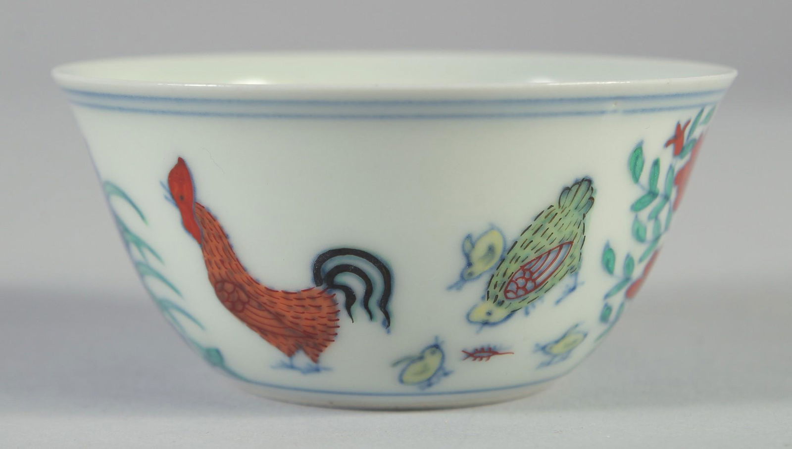 A CHINESE DOUCAI PORCELAIN CHICKEN CUP, six-character mark to base, 8cm diameter.: A CHINESE DOUCAI PORCELAIN CHICKEN CUP, six-character mark to base, 8cm diameter.