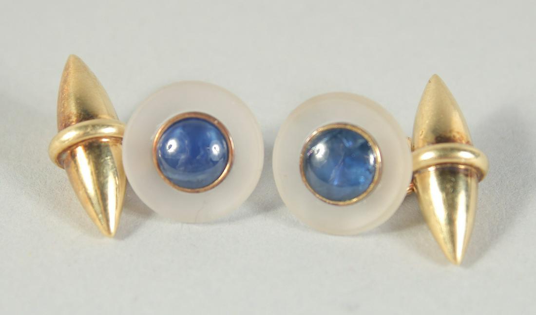 A GOOD PAIR OF 18 CT GOLD AND SAPPHIRE CUFF LINKS on a chain.: A GOOD PAIR OF 18 CT GOLD AND SAPPHIRE CUFF LINKS on a chain.
