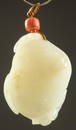 A FINE 18TH CENTURY CARVED JADE LOTUS ROOT PENDANT, with coral bead and hallmarked metal, 4.5cm