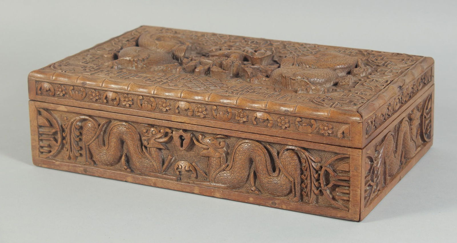 A FINE CHINESE CARVED WOOD DRAGON CIGAR BOX, the hinged lid with two relief dragons and a bird, 32cm (1 of 4)