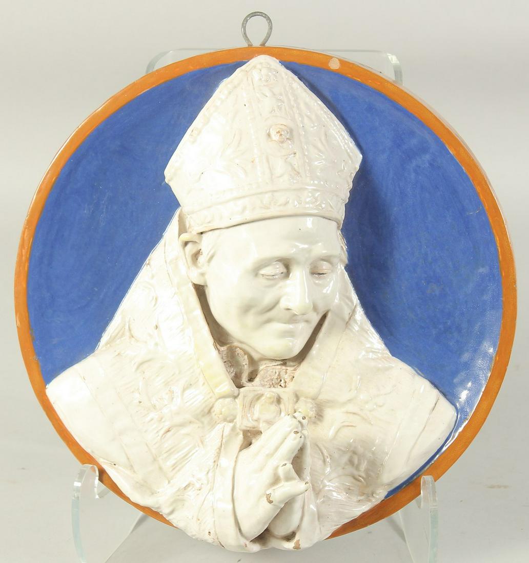 A CONTINENTAL GLAZED POLYCHROME TERRA COTTA ROUNDEL of a praying Bishop on a blue background.  32cm (1 of 4)