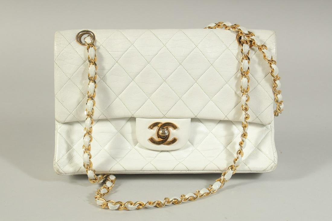 A CHANEL WHITE PADDED LEATHER EVENING BAG, 8.5ins long, with a gilt and white leather entwined strap (1 of 6)