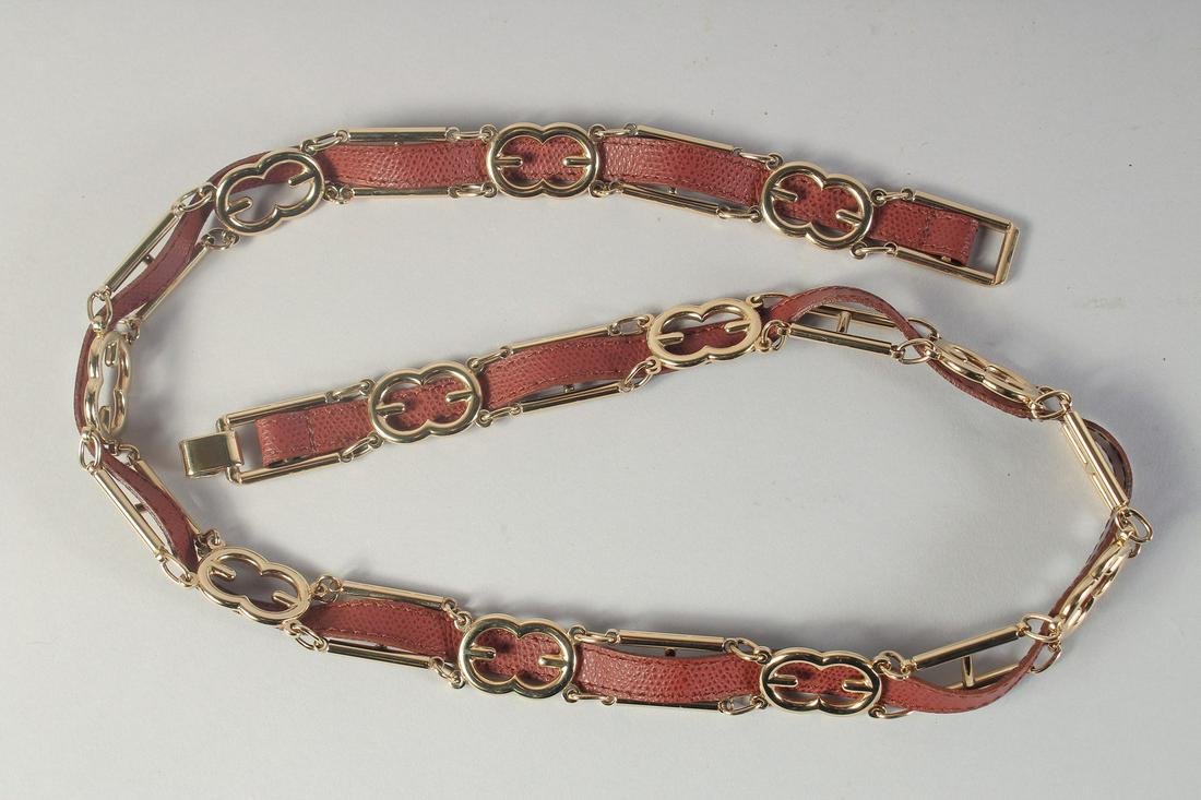 AN ESCADA GILT & LEATHER BELT. No. 51230 -972 Escada, Made in Italy. 36ins long.: AN ESCADA GILT & LEATHER BELT. No. 51230 -972 Escada, Made in Italy. 36ins long.
