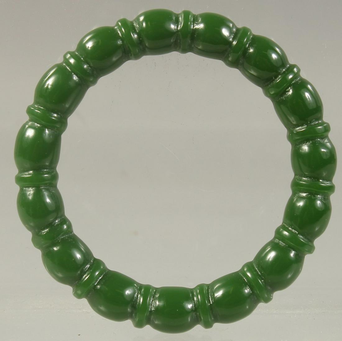 A CHINESE CARVED GREEN JADE BANGLE.  2.75ins (1 of 1)