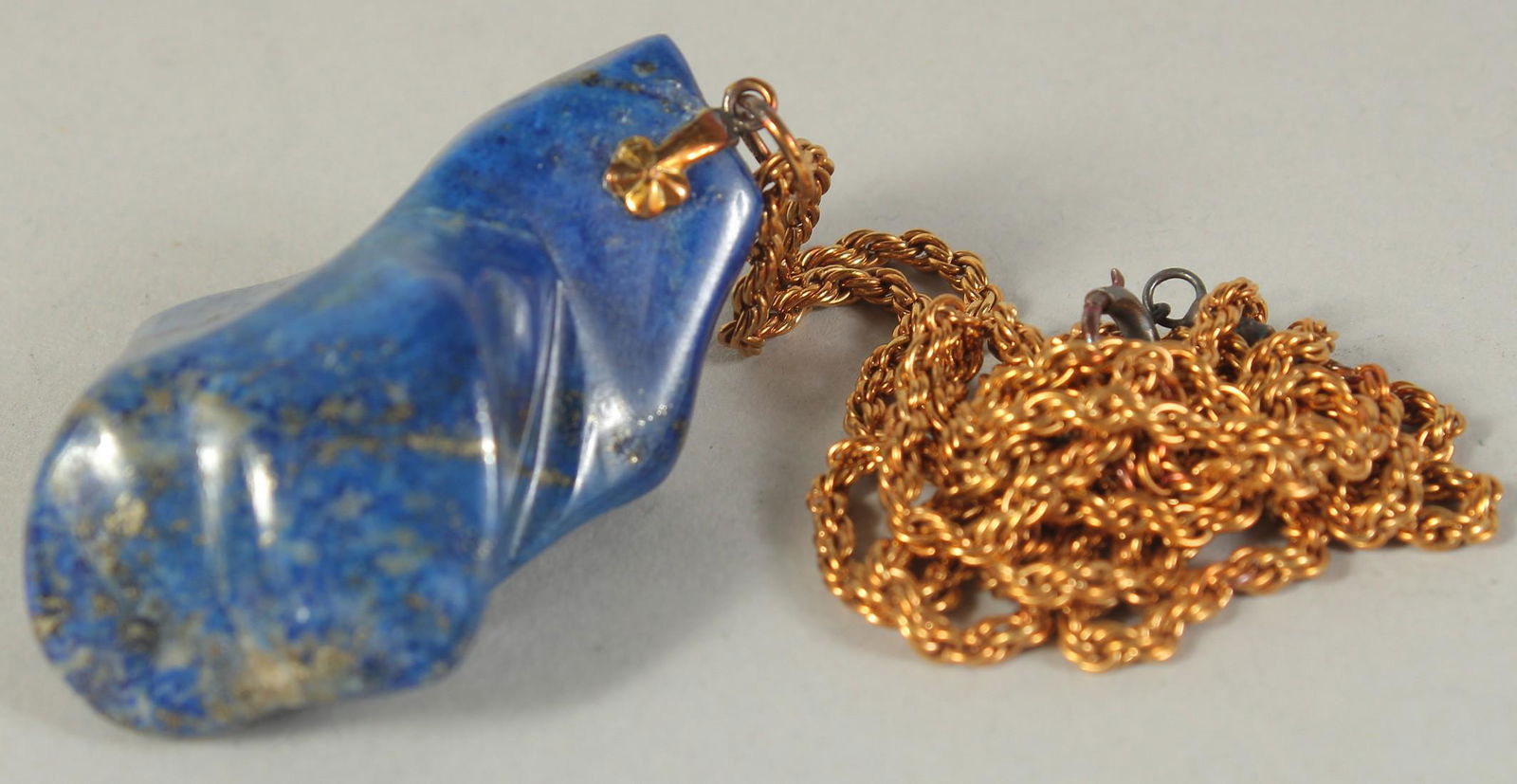 A GOOD PIECE OF LAPIS on a gold chain. Lapis 40gms.: A GOOD PIECE OF LAPIS on a gold chain. Lapis 40gms.
