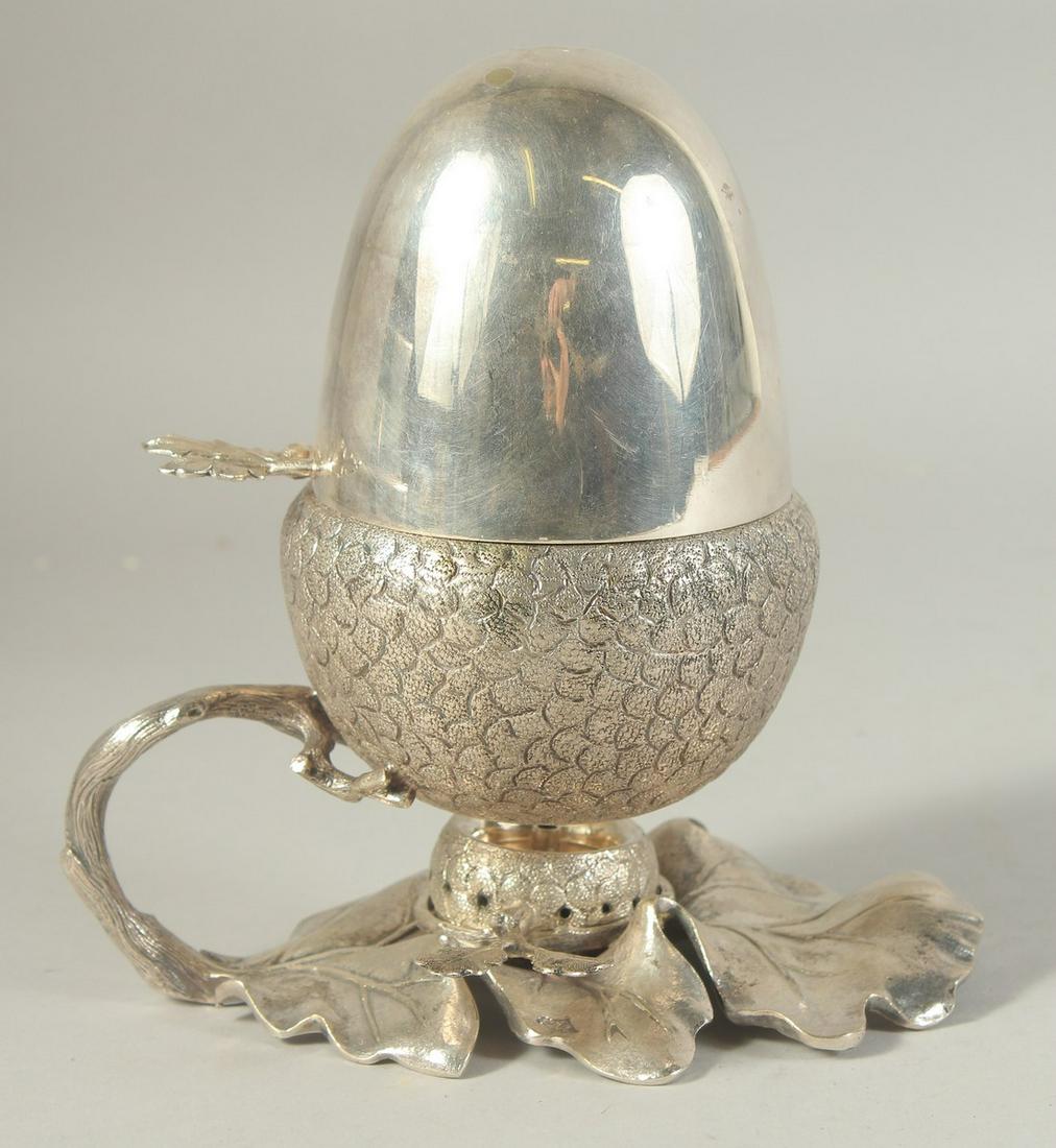A SILVER PLATED ACORN EGG COASTER 7.5ins.: A SILVER PLATED ACORN EGG COASTER 7.5ins.
