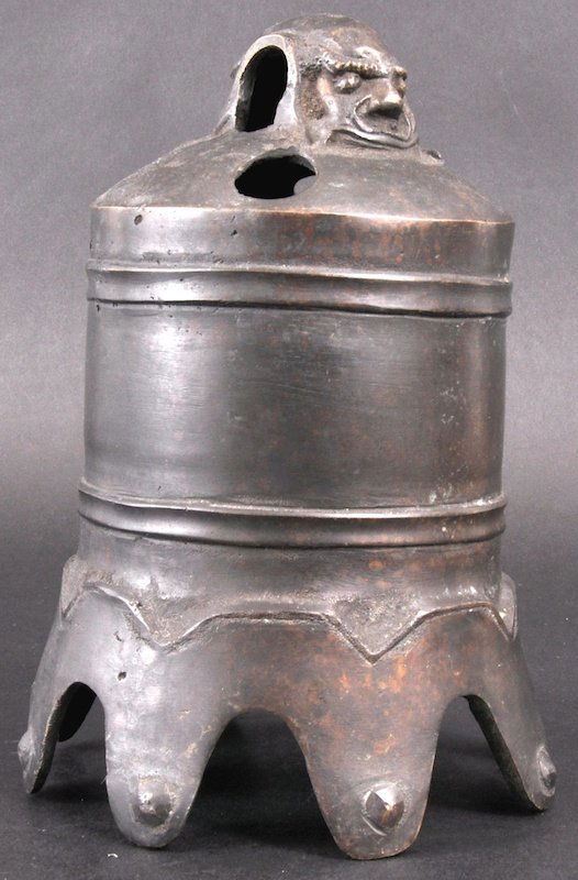 A CHINESE HANGING BRONZE BELL with figural termin: A CHINESE HANGING BRONZE BELL with figural terminal, decorated in relief with calligraphy. Few holes, some wear. 8. 5ins high.