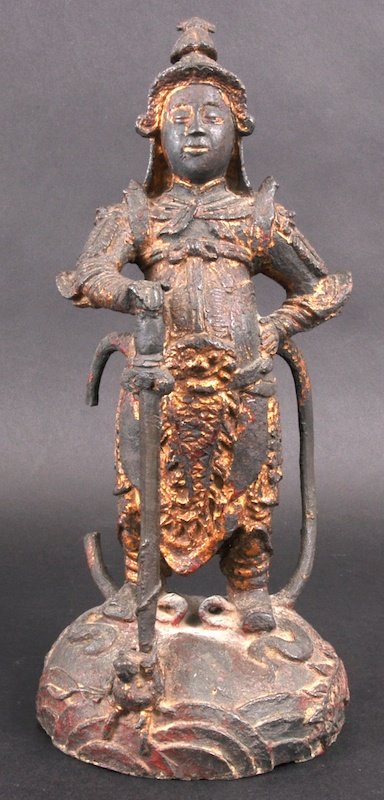 A 16TH/17TH CENTURY CHINESE BRONZE AND LACQUERED : A 16TH/17TH CENTURY CHINESE BRONZE AND LACQUERED FIGURE the warrior modelled standing with a sword in one hand, modelled with hands on his waist, standing upon a naturalistic base. Few losses to mount