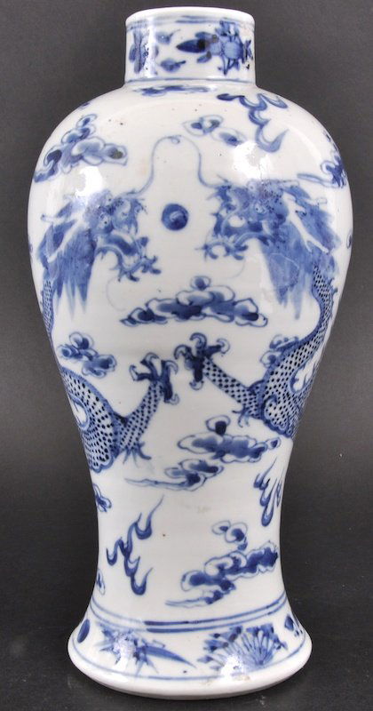 AN EARLY 19TH CENTURY CHINESE BLUE AND WHITE BALU: AN EARLY 19TH CENTURY CHINESE BLUE AND WHITE BALUSTER VASE bearing Kangxi marks to base, painted with dragons pursing a flaming pearl. Two nicks and small hairline to rim. 10. 25ins high.