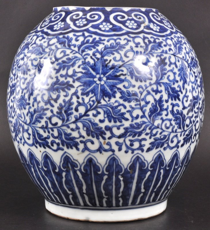 AN 18TH CENTURY CHINESE BLUE AND WHITE BALUSTER V: AN 18TH CENTURY CHINESE BLUE AND WHITE BALUSTER VASE Qianlong period, painted with bold floral sprays and foliage, under a border of motifs. Rim ground down, filled hole to base. 10. 25ins high.