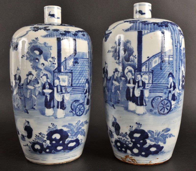 A NEAR PAIR OF 19TH CENTURY CHINESE BLUE AND WHITE: A NEAR PAIR OF 19TH CENTURY CHINESE BLUE AND WHITE PORCELAIN VASES bearing Kangxi marks to base, painted with figures within a garden. One with damage, both drilled.11.5ins & 11ins high.
