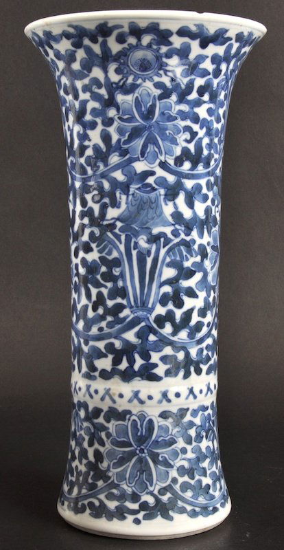 A LATE 19TH CENTURY CHINESE BLUE AND WHITE VASE be: A LATE 19TH CENTURY CHINESE BLUE AND WHITE VASE bearing Kangxi marks to base, painted with foliage. Chip to inner rim.11.75ins high.