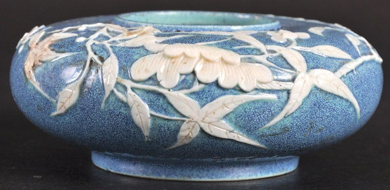 A 19TH CENTURY CHINESE ROBINS EGG CIRCULAR BRUSH: A 19TH CENTURY CHINESE ROBINS EGG CIRCULAR BRUSH WASHER overlaid in relief with white decorated flowers. Part of flower restored.4.25ins diameter. Provenance: Fongs Gallery, Sao Paulo.