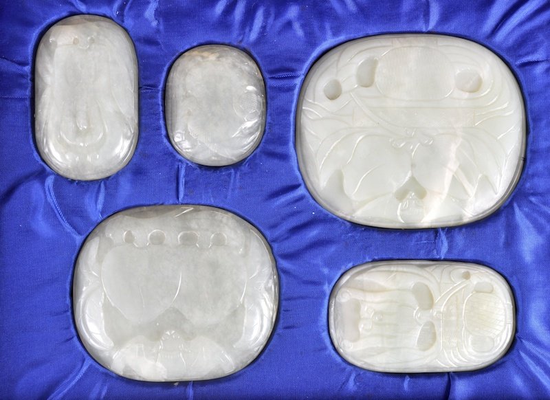 A GROUP OF EARLY 20TH CENTURY CHINESE HARDSTONE: A GROUP OF EARLY 20TH CENTURY CHINESE HARDSTONE PLAQUES probably Jade, decorated with bats, foliage and motifs. Good condition.