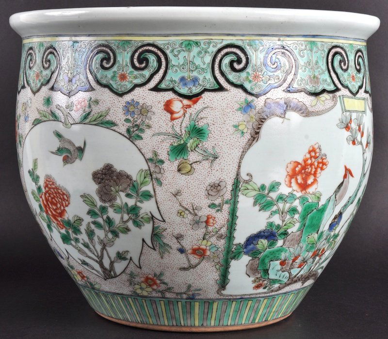 A 19TH CENTURY CHINESE FAMILLE VERTE FISH BOWL o: A 19TH CENTURY CHINESE FAMILLE VERTE FISH BOWL of Kangxi design, enamelling with flowering rock, with unusual bat capped cartouches. Good condition.14.5ins diameter.