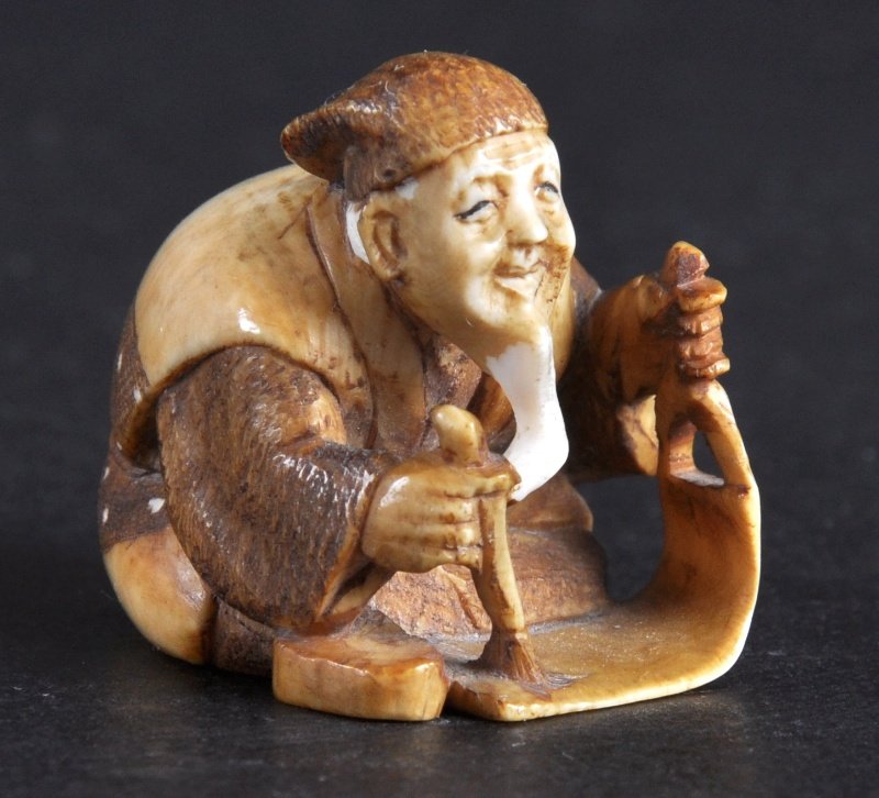 A LOVELY LATE 19TH CENTURY JAPANESE MEIJI PERIOD S: A LOVELY LATE 19TH CENTURY JAPANESE MEIJI PERIOD STAINED IVORY NETSUKE modelled as an elderly scholar. Signed. Good condition.1.5ins wide.