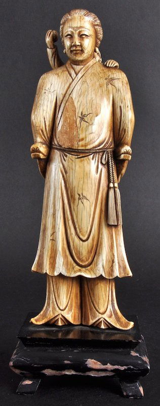 A GOOD 19TH CENTURY CHINESE IVORY FIGURE OF A FE: A GOOD 19TH CENTURY CHINESE IVORY FIGURE OF A FEMALE Qing Dynasty, wearing robes decorated with foliage, a child upon her back. Minor loss to dress. Ivory 8.5ins high.